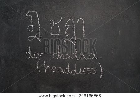 Thai letter written with white chalk on blackboard