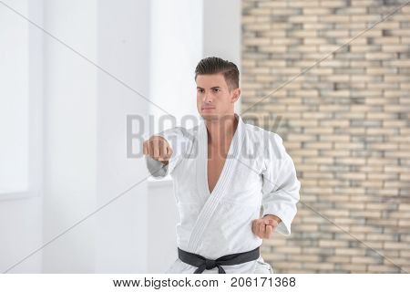 Male karate instructor training in dojo