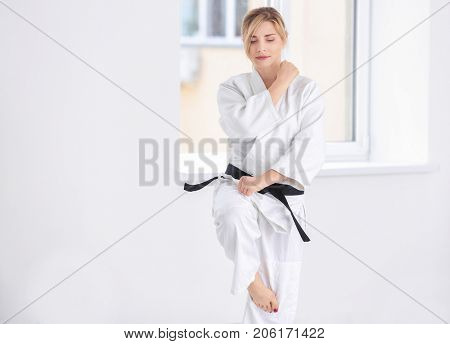 Female karate instructor training in dojo