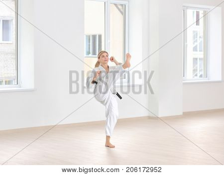 Female karate instructor training in dojo