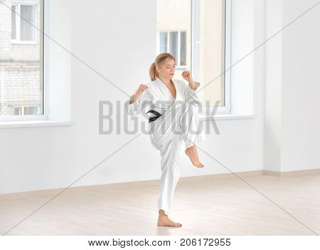 Female karate instructor training in dojo