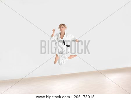 Female karate instructor training in dojo