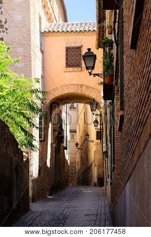 Typical narrow street on the medieval city of Toledo in Spain