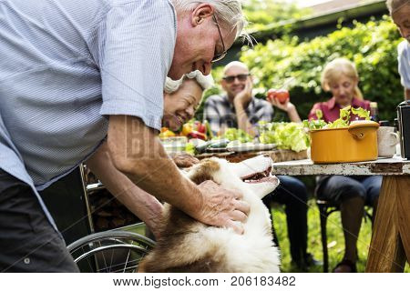 Senior man playing with siberian huskey