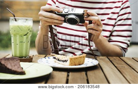 Woman holiday lifestyle taking photo cake dessert
