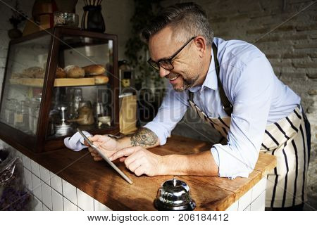 Man using devices for online business order at bakehouse