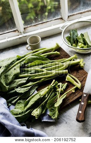 Aerial view of fresh collard chinese kale on wooden cutboard