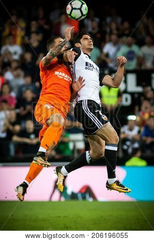 VALENCIA, SPAIN - SEPTEMBER 19: (L) Cifuentes and Guedes during Spanish La Liga match between Valencia CF and Malaga CF at Mestalla Stadium on September 19, 2017 in Valencia, Spain