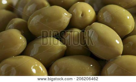 Large shiny green olives macro for background