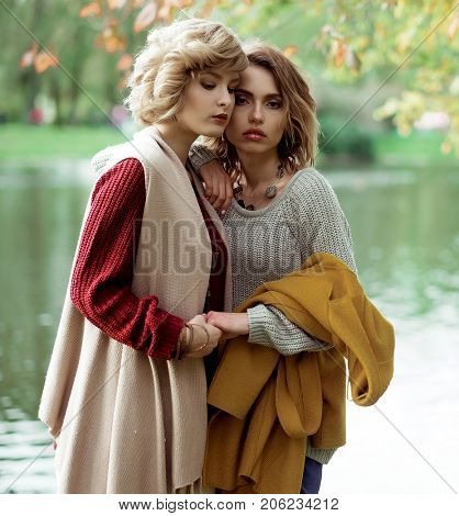 Young beautiful women near lake. Glamour fashion portrait.