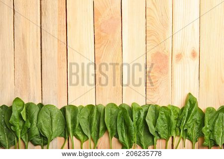 Fresh spinach leaves on wooden background