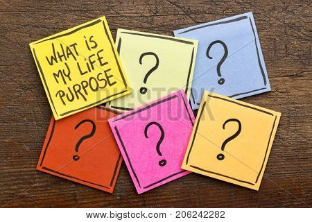 What is my life purpose?  Handwriting on sticky notes with multiple question marks