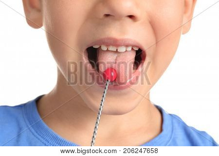 Cute boy with logopedic probe for speech correction on white background, closeup