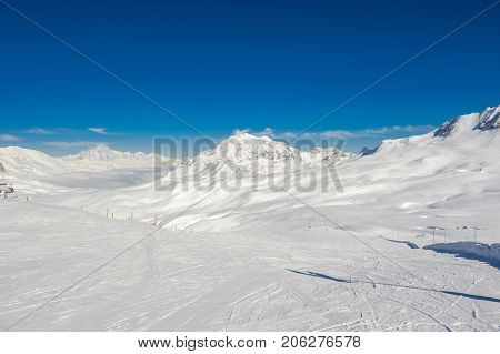 Alpine winter mountain landscape. French Alps covered with snow in sunny day. Val-d'Isere, France