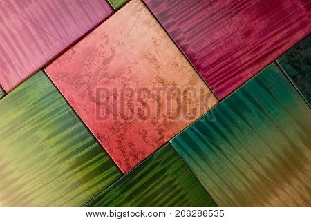 Prized figured wood, grain or wood samples in many colors aligned diagonally. Birdseye (birds eye) and curly or tiger stripe patterns.  stained and finished with clear lacquer.