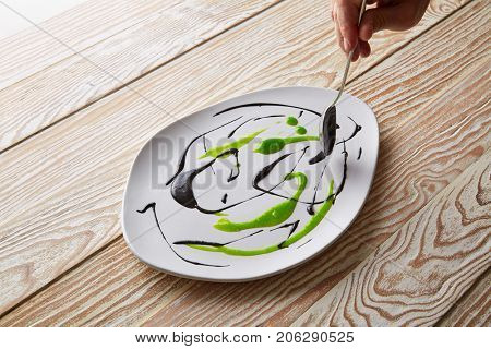 Modern cuisine chef preparation with creamy spots Molecular gastonomy