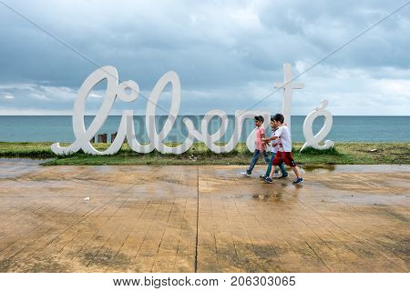 Batumi, Georgia - August 28, 2017: Installation letters Liberte on the beach and kids in Batumi, Georgia