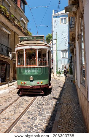 Old Tram Number 28 On The Narrow Street Of Alfama. Lisbon. Portugal