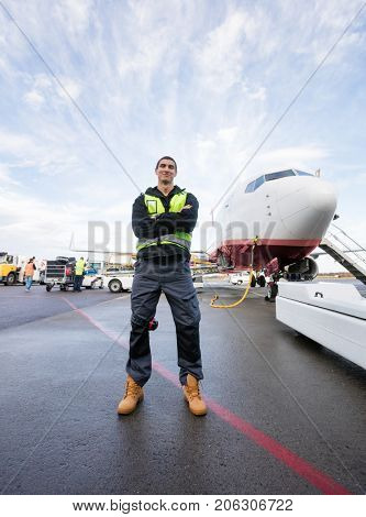 Confident Worker Standing Arms Crossed On Wet Runway