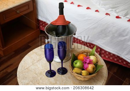 Fruits and champagne in hotel room prepared for romantic date