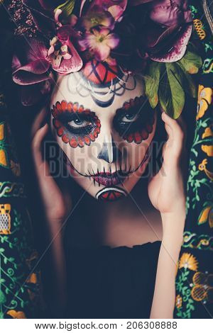 Closeup portrait of Calavera Catrina. Young woman with sugar skull makeup. Dia de los muertos. Day of The Dead. Halloween.