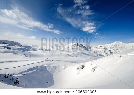 Alpine winter mountain landscape. French Alps covered with snow in sunny day. Val-d'Isere, France
