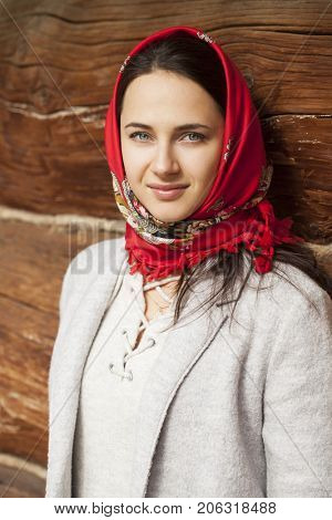 Russian girl. Portrait of beautiful young brunette woman in red russian neckerchief
