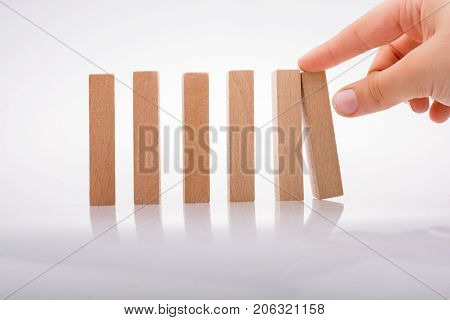 Hand Holding Wooden Domino