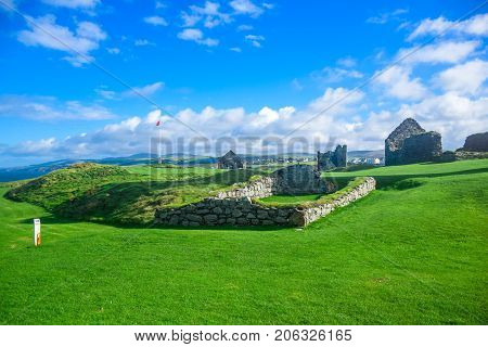 Scenery view of Peel Castle constructed by vikings on top of Peel hill on a clear blue sky, Isle of Man