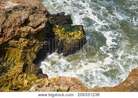 Rocks And Waves Of Surf In The Ocean Near Farol De Nazare Coast In Portugal