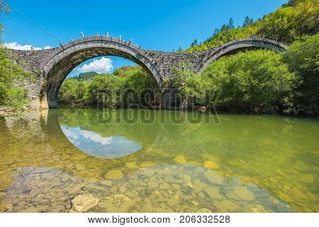 Arches stone bridge of Kalogeriko (or Plakida) on the river of Voidomatis. Central Zagoria Epirus Greece