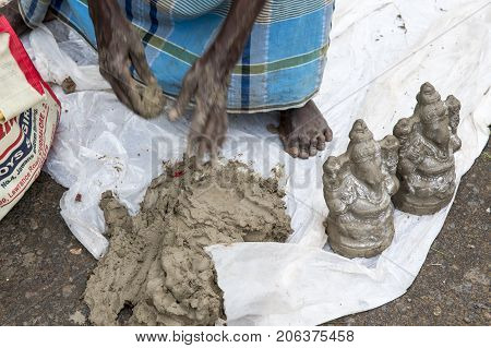 Close up of hand crafted Ganesha idol clay statues displayed in the market during Ganesh Festival.