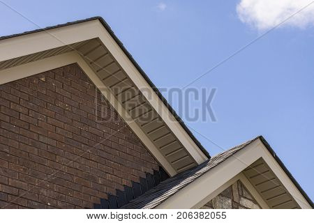 Roof Showing Soffit On The Front Of A Brick And Stone House.