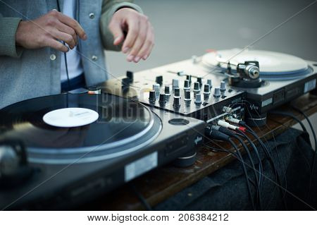 turntable scratch, hand of dj on the vinyl record