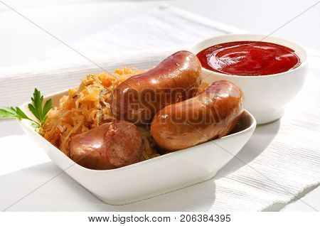 Grilled Sausages, Potatoes And Sauerkraut On Cooking Pan