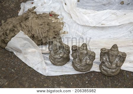 Close up of hand crafted Ganesha idol clay statues displayed in the market during Ganesh Festival.