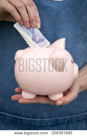 Placing Notes In A Piggybank