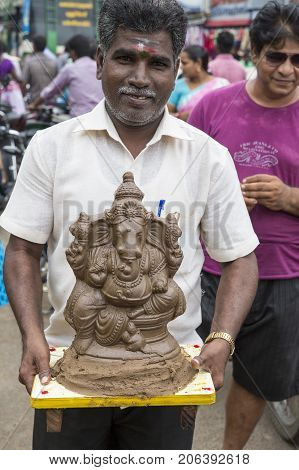 Close up of hand crafted Ganesha idol clay statues displayed in the market during Ganesh Festival.