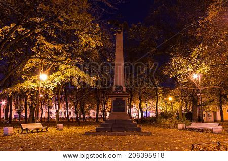 Night autumn view of illuminated monument to Heroes of Battleship "Emperor Alexander 3" in Nikolskiy garden St. Petersburg Russia