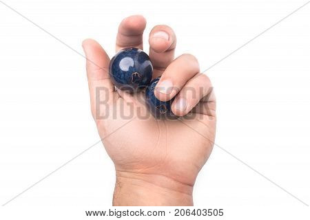 Chinese balls Yin Yan for health in hand isolated on white background