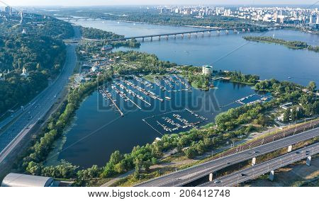 Aerial top view of Darnitsky bridge, Dnieper river and cityscape from above, city of Kiev, Ukraine