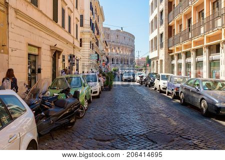 ROME,ITALY - JULY 18, 2017 : Street scene in Rome with the ruins of the Colosseum on the background