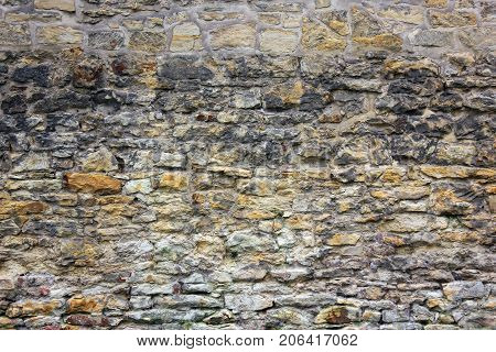 Ancient brick wall with different size of stones.