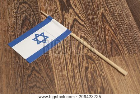 Flag of Israel on a wooden background .