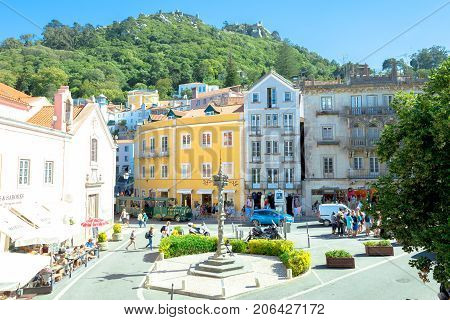 Sintra, Portugal - August 8, 2017: Aerial view of the Old pelourinho or column of punishment and Castle of the Moors on top of a hill above Sintra in Historic Center, Unesco World Heritage Site.