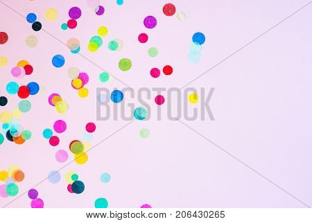 Festive party or carnival confetti on pink background