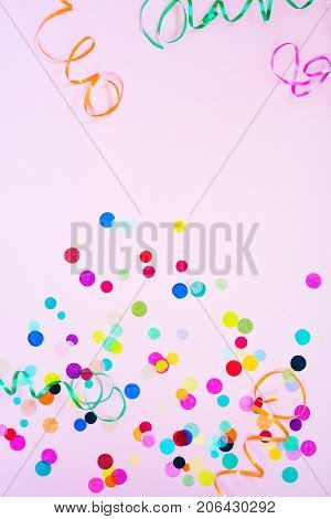 Festive party or carnival confetti on pink background