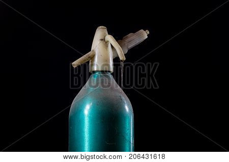 Old Dusty Siphon On Black Background. The Cobwebs Entwining The Old Siphon Into Soda Water.