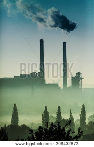 Power station with smoking chimney symbol of environmental pollution