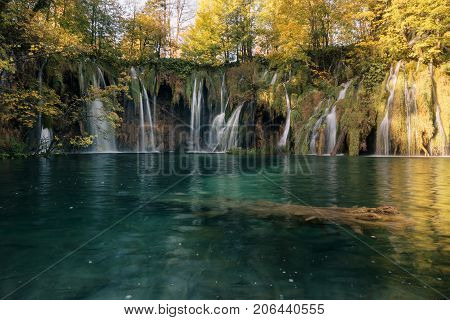 Beautiful waterfall landscape. Scenic cascade with lake and forest for travel outdoor activity and autumn vacation.